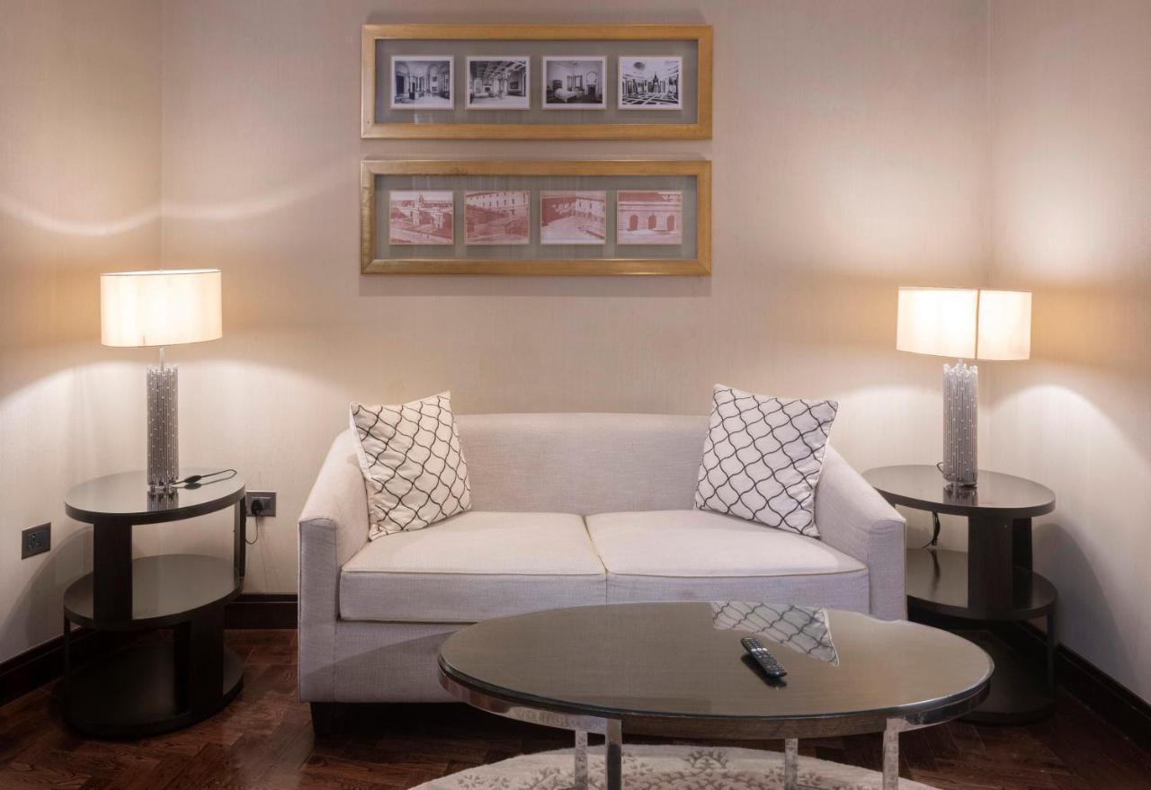 The Claridges New Delhi Hotel Exterior photo A living room with a sofa